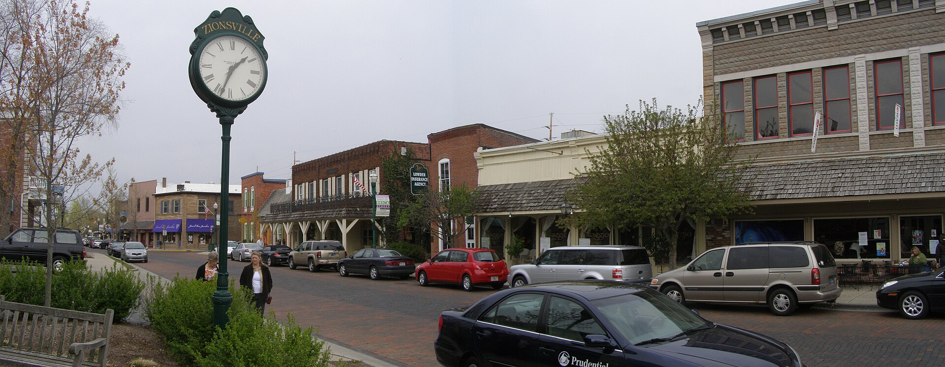 Brick-paved Main Street, shops, and town clock in Zionsville, Indiana